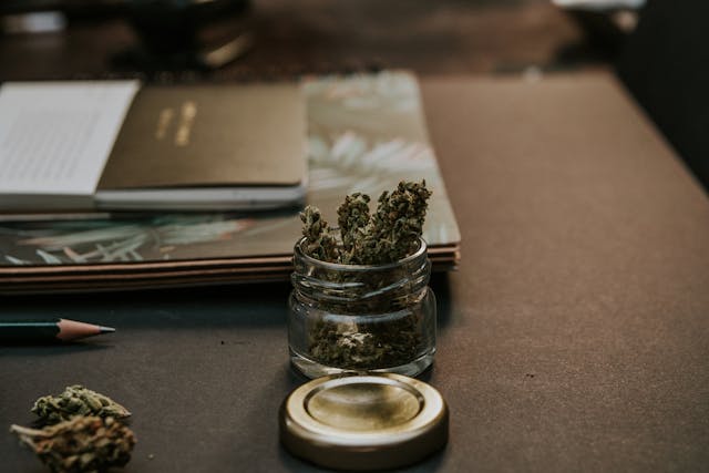 A jar of weed sitting on table